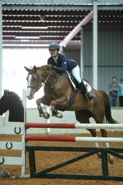 Tiffany jumping LH Annie-Elka in the Junior class at Tonimbuk Indoor